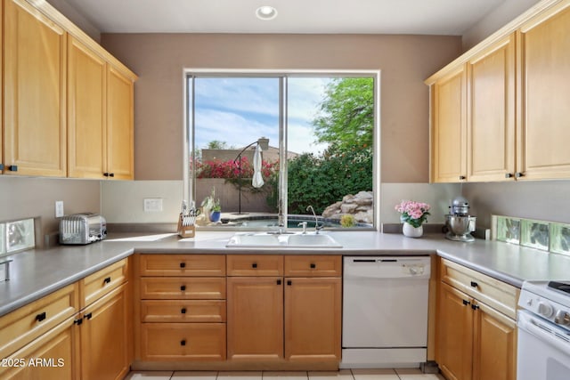 kitchen featuring recessed lighting, light countertops, dishwasher, light brown cabinets, and a sink