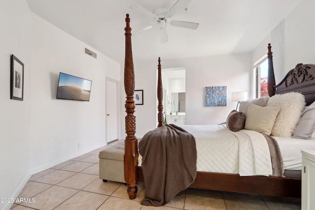 bedroom with a ceiling fan, ensuite bathroom, light tile patterned flooring, baseboards, and visible vents