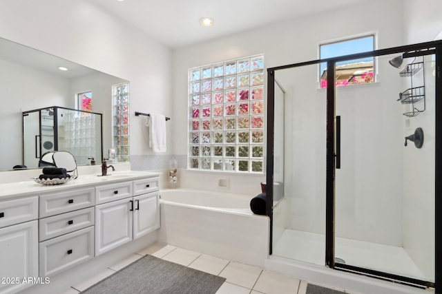full bath featuring a bath, plenty of natural light, a stall shower, and tile patterned floors
