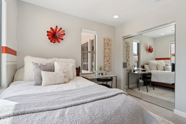 bedroom with recessed lighting, a closet, carpet flooring, and baseboards