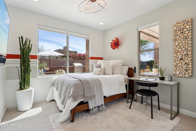 bedroom with baseboards, carpet floors, a chandelier, and multiple windows
