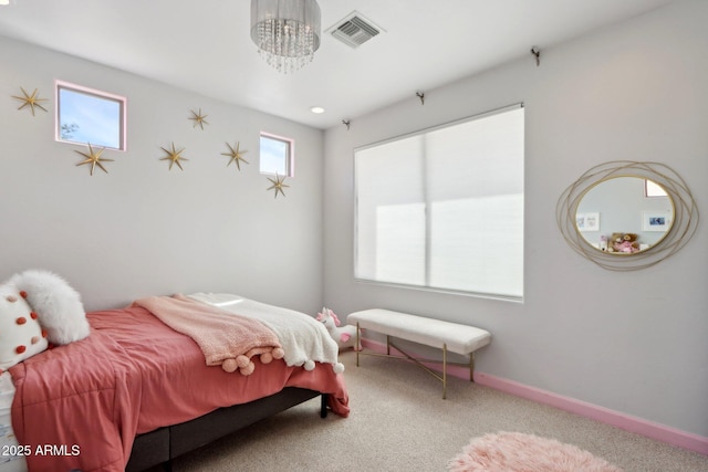 carpeted bedroom with baseboards, a chandelier, and visible vents