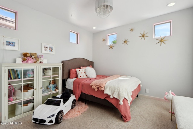 carpeted bedroom featuring baseboards, recessed lighting, and a chandelier