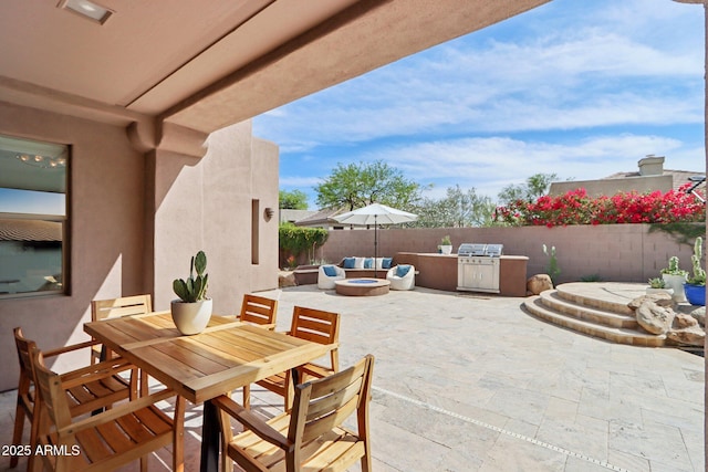 view of patio / terrace with outdoor dining area, a fenced backyard, an outdoor fire pit, and area for grilling