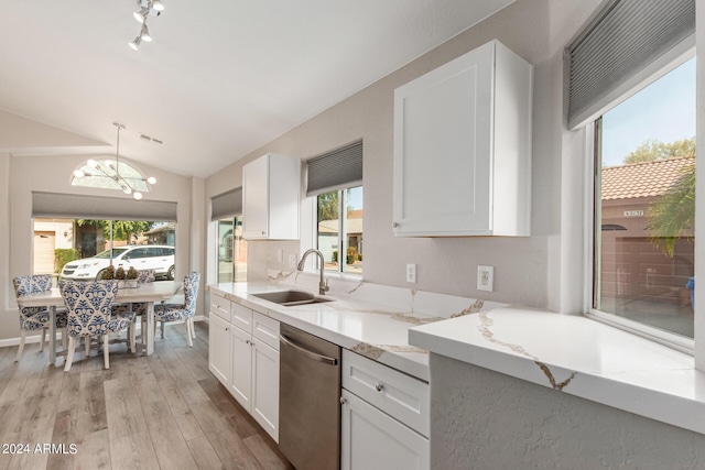 kitchen with pendant lighting, stainless steel dishwasher, white cabinetry, a sink, and light stone countertops