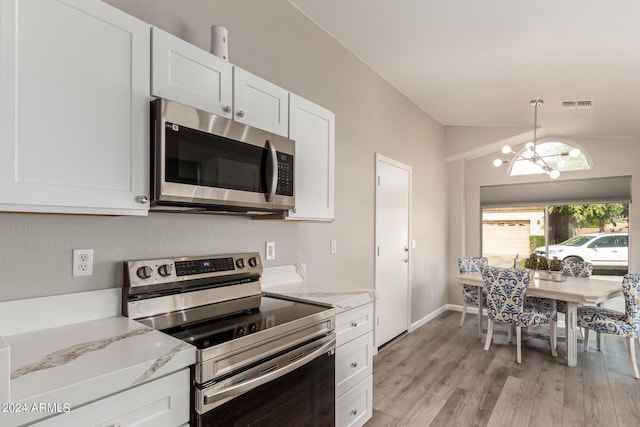 kitchen featuring light stone counters, stainless steel appliances, visible vents, light wood-style flooring, and white cabinetry