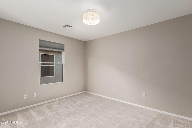 unfurnished room with light carpet, baseboards, and visible vents