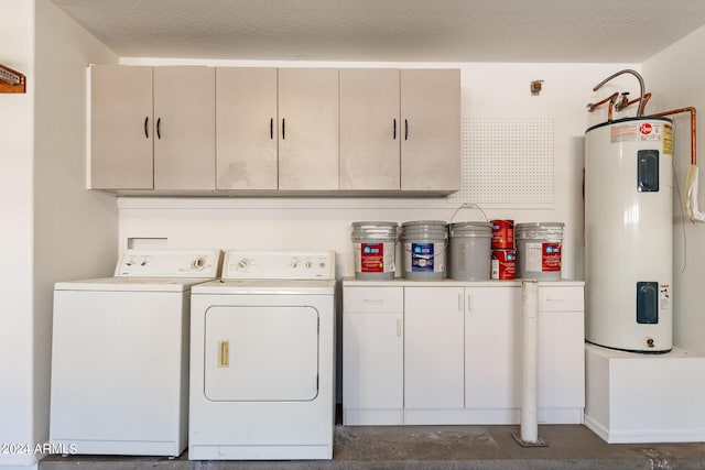 washroom featuring a textured ceiling, separate washer and dryer, cabinet space, and electric water heater