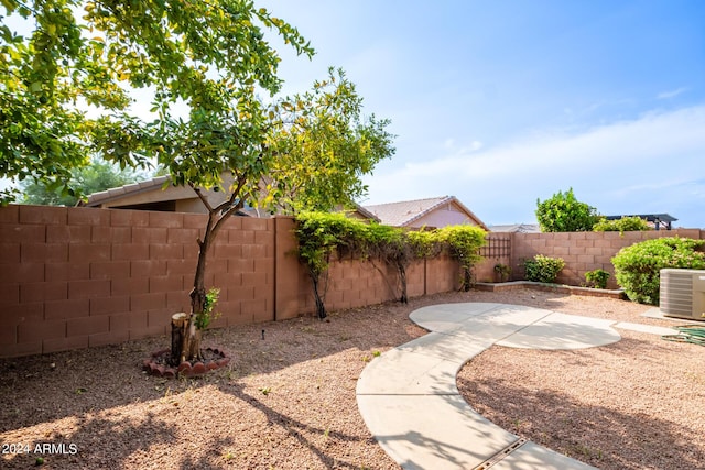 view of yard featuring a patio area, a fenced backyard, and central AC