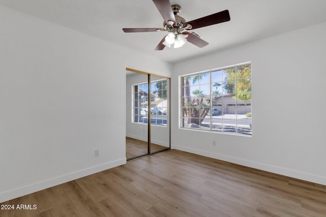 unfurnished bedroom featuring a closet, ceiling fan, and light hardwood / wood-style flooring