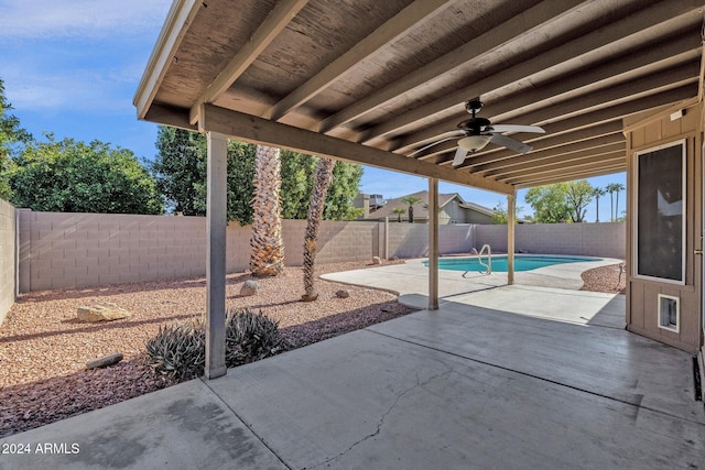 view of patio / terrace with ceiling fan and a fenced in pool