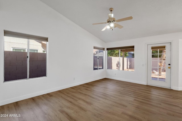 unfurnished room featuring hardwood / wood-style flooring, vaulted ceiling, and ceiling fan