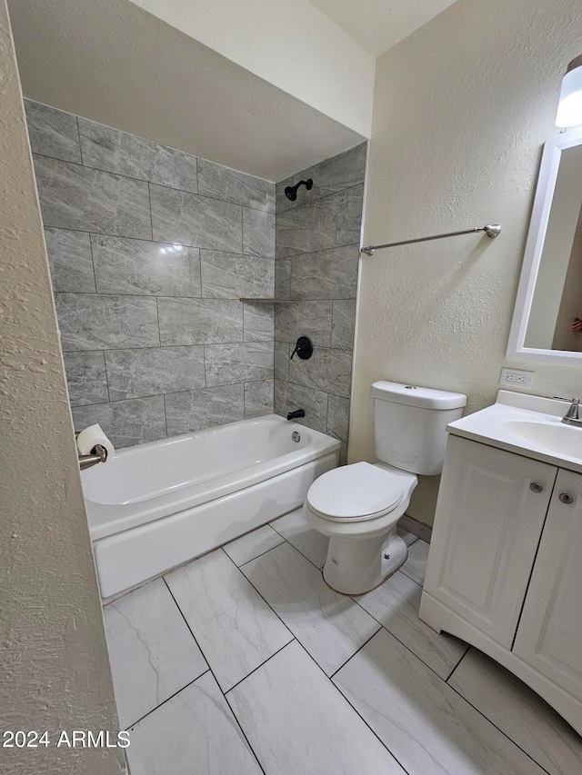 full bathroom with vanity, tiled shower / bath combo, and toilet