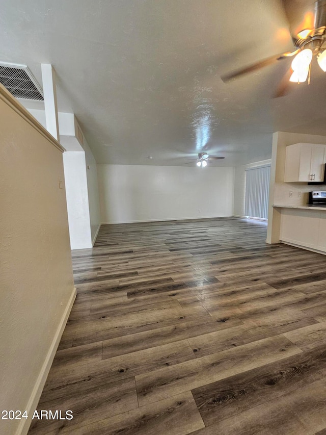 interior space with dark wood-type flooring and ceiling fan