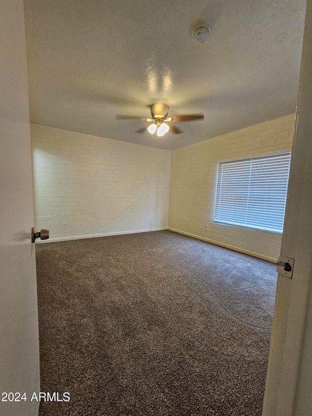 unfurnished room with ceiling fan and carpet flooring