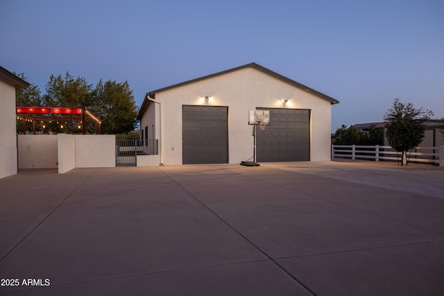 view of garage at dusk