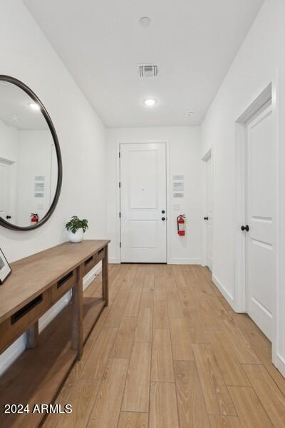 corridor with light wood-type flooring