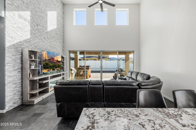 living room featuring a towering ceiling and ceiling fan