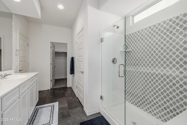 bathroom with walk in shower and vanity