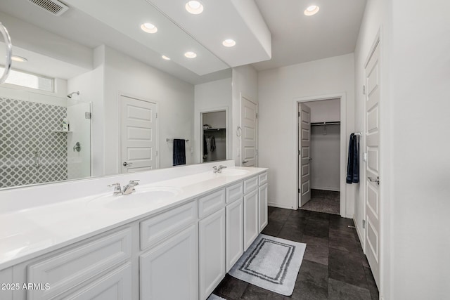 bathroom with walk in shower and vanity