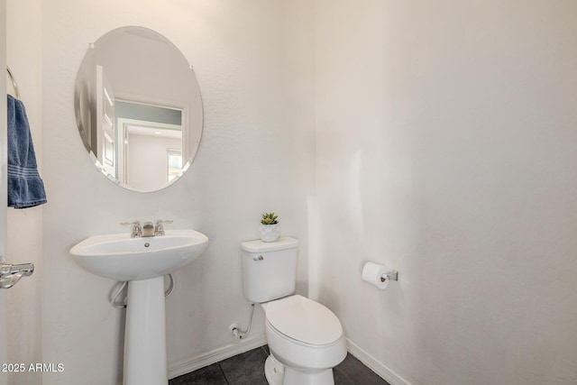 bathroom with sink, toilet, and tile patterned flooring