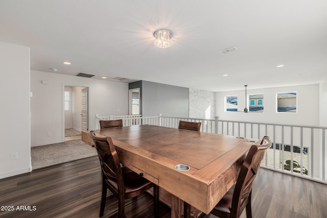 dining space featuring dark hardwood / wood-style flooring