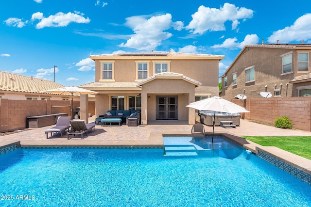 2185 E Gillcrest Rd, Gilbert, AZ 85298 - back of property featuring an outdoor hangout area, roof mounted solar panels, a fenced backyard, a hot tub, and french doors