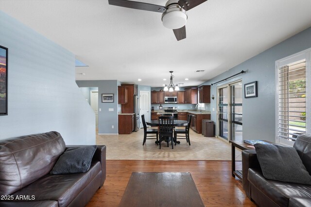 2185 E Gillcrest Rd, Gilbert, AZ 85298 - living room with ceiling fan, a chandelier, light wood-type flooring, and recessed lighting