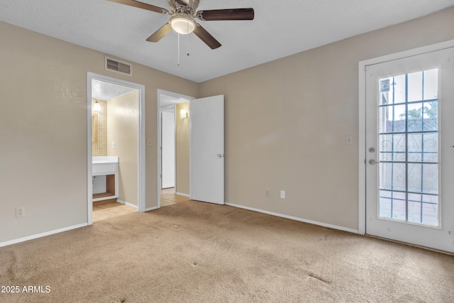 unfurnished bedroom featuring visible vents, baseboards, carpet flooring, and multiple windows