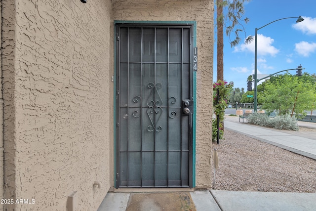 property entrance featuring stucco siding