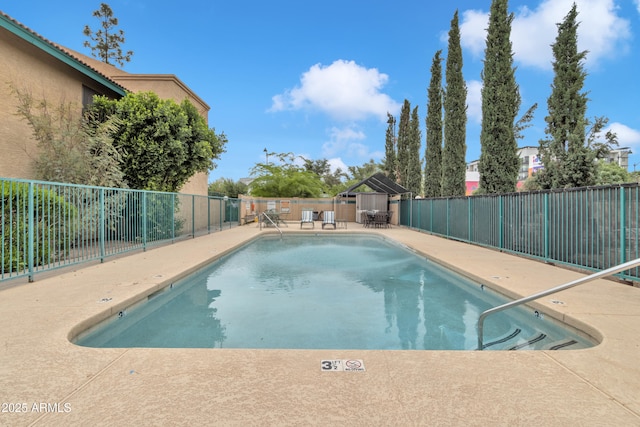 pool featuring a fenced backyard, a gazebo, and a patio