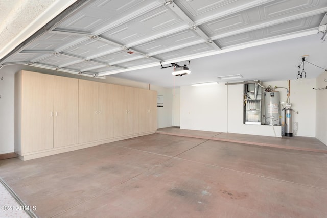 garage featuring a garage door opener and water heater