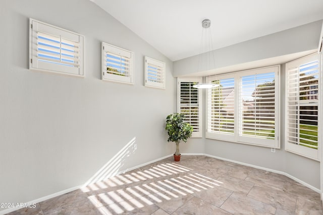 spare room featuring vaulted ceiling