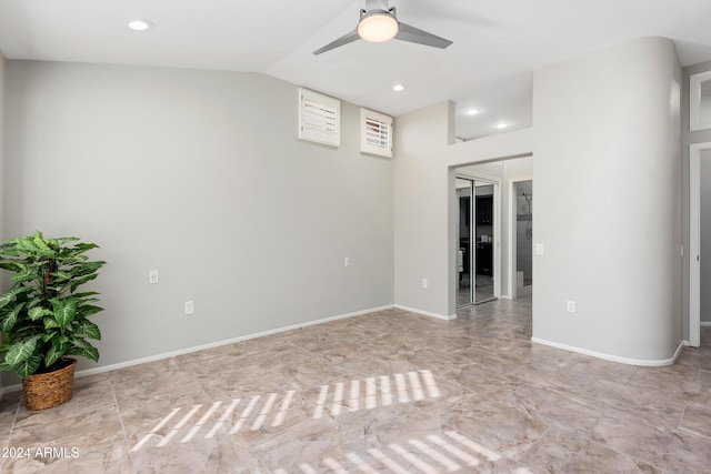 unfurnished room with ceiling fan and vaulted ceiling