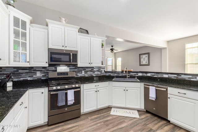 kitchen featuring white cabinets, wood-type flooring, sink, and appliances with stainless steel finishes