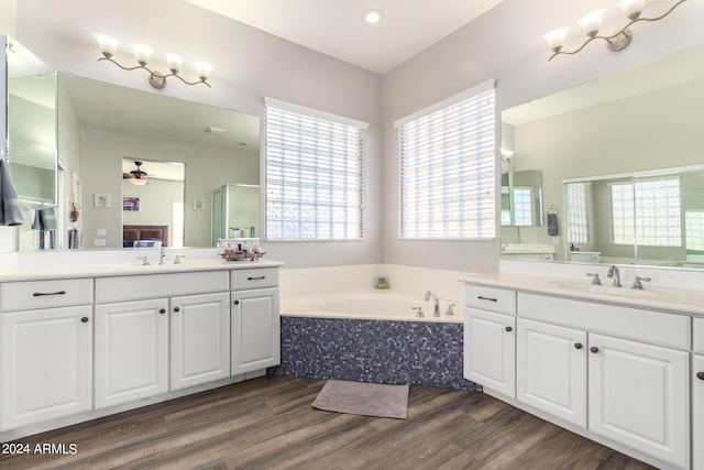 bathroom with hardwood / wood-style floors, ceiling fan, vanity, and a wealth of natural light