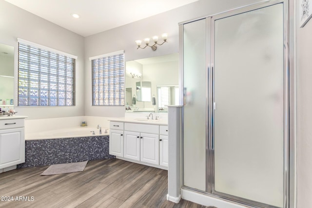 bathroom featuring separate shower and tub, hardwood / wood-style floors, and vanity