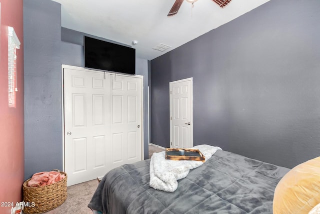 bedroom featuring ceiling fan, a closet, and carpet