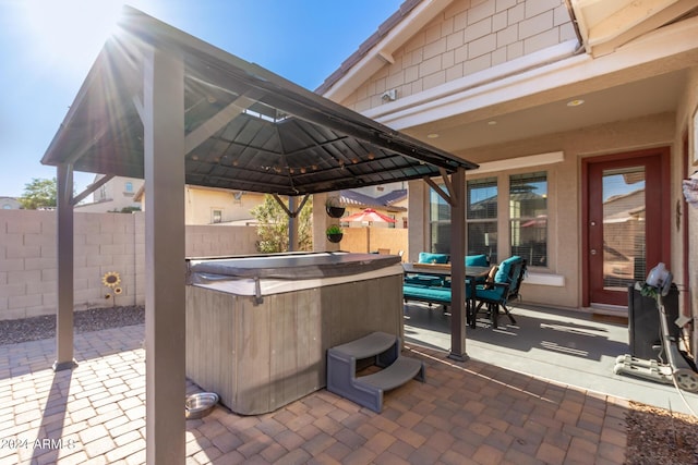 view of patio featuring a gazebo and a hot tub