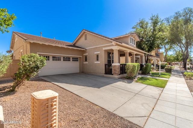 view of front of property with a porch and a garage