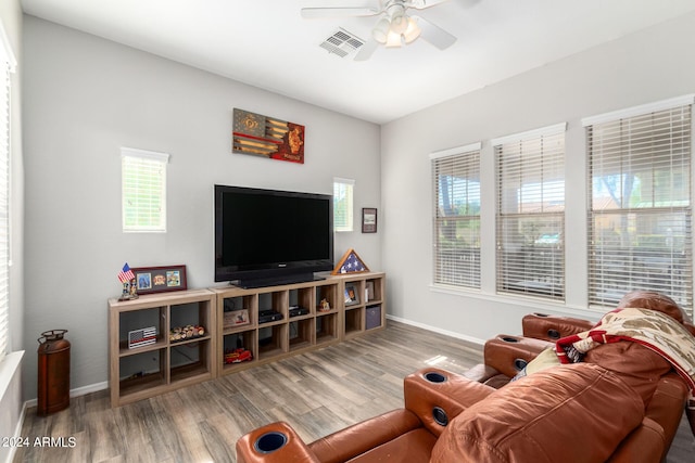 living room with hardwood / wood-style flooring and ceiling fan