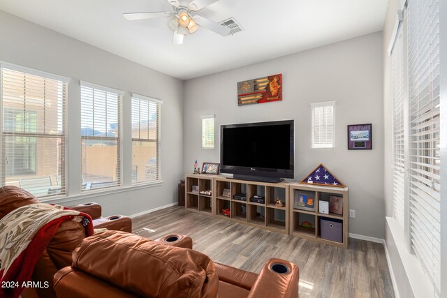 living room with ceiling fan and hardwood / wood-style flooring