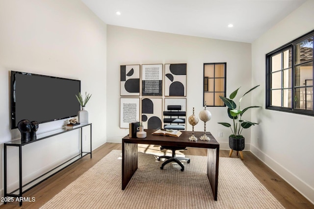 office with wood-type flooring and vaulted ceiling