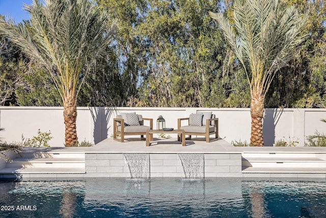 view of swimming pool with a patio and pool water feature