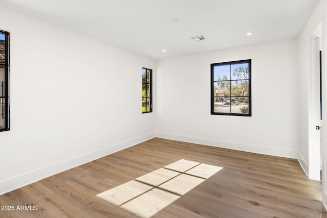 unfurnished room with wood-type flooring