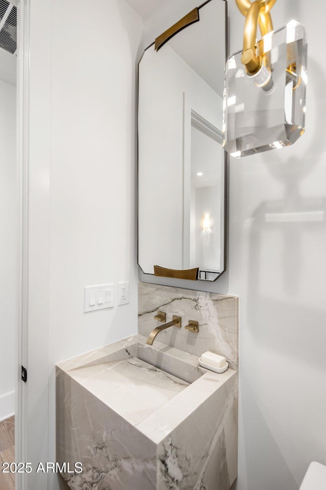 bathroom with a chandelier