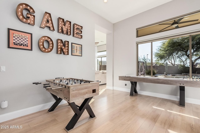 rec room with ceiling fan and light hardwood / wood-style flooring