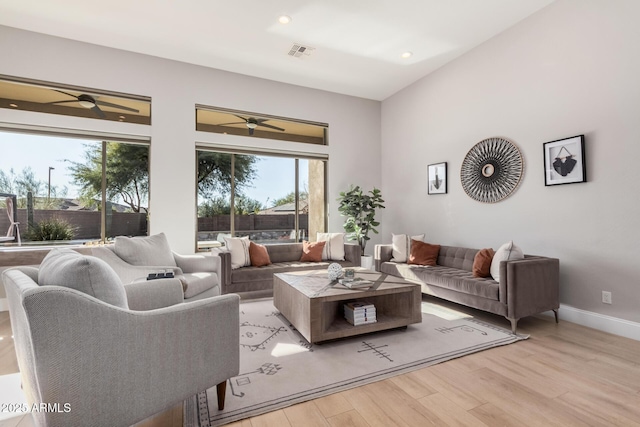 living room featuring ceiling fan, a healthy amount of sunlight, and light hardwood / wood-style floors