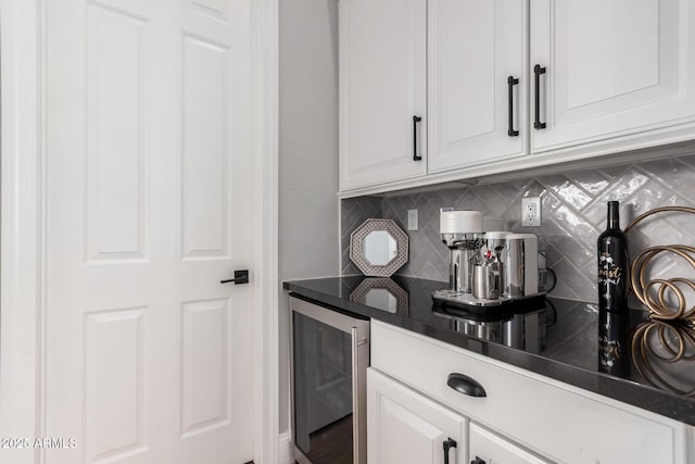 kitchen with beverage cooler, white cabinetry, and decorative backsplash