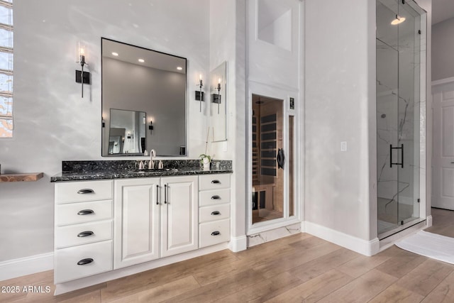 bathroom with an enclosed shower and vanity